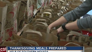 Volunteers pack Thanksgiving meals for families