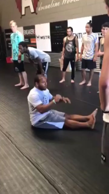 Incredibly athletic man performs multiple impressive flips from a sitting position