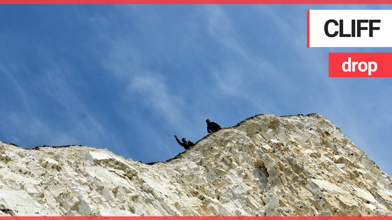 Pair snapped sitting on the edge of notoriously dangerous 500-foot cliff