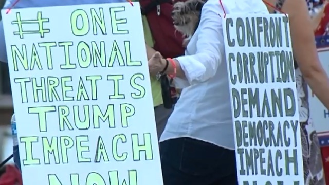 People march to Mar-a-Lago in candlelight vigil