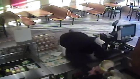 Suspect dives over counter for cash drawer at Subwayii