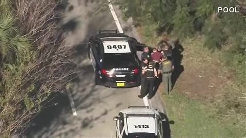 Florida police place mass shooting suspect in car