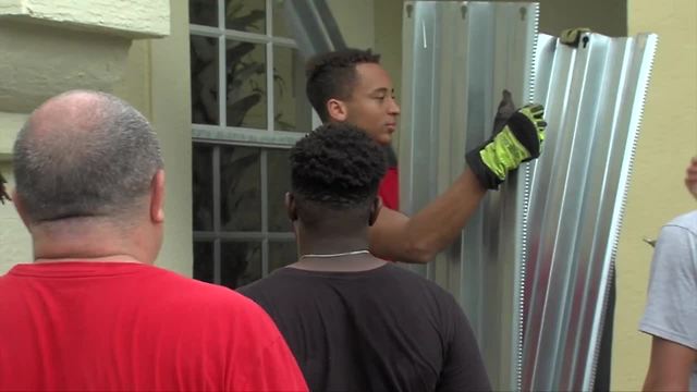 Palm Beach Central High School Football team installs shutters for community as Irma approaches