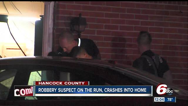 Robbery suspect on the run after crash into Hancock County home
