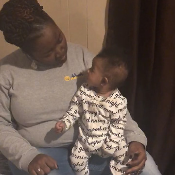 A Baby Girl Doing The Wakanda Forever Salute