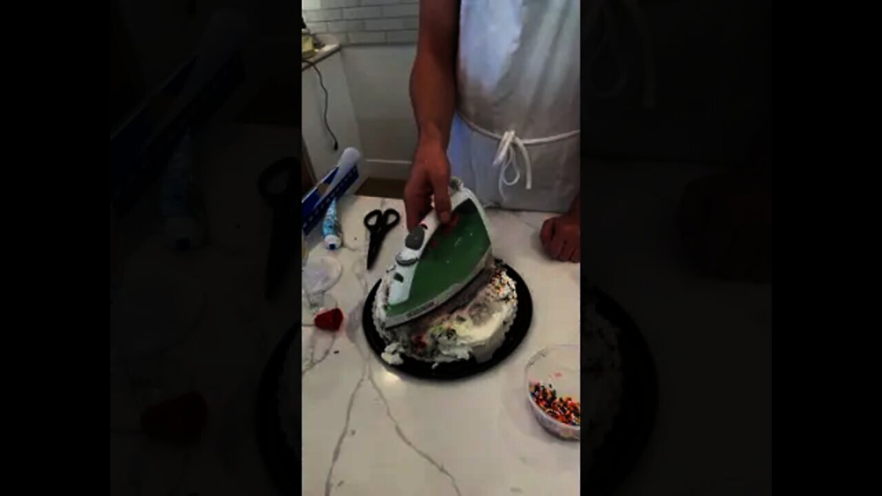 When he lifts the iron off the cake, it looks incredible!