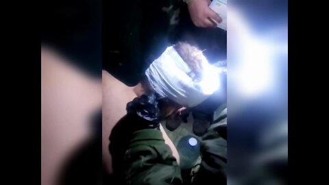 Russian medic assists a captured soldier of the Armed Forces of Ukraine