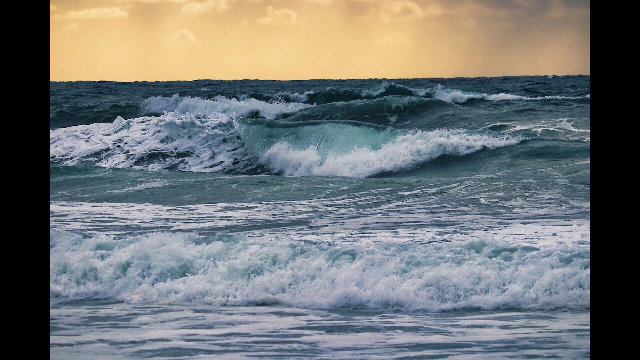 Ocean surf. Waves roll over the rocks.