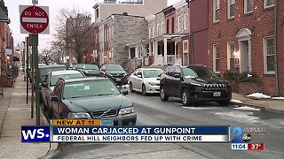 Woman carjacked at gunpoint in Federal Hill