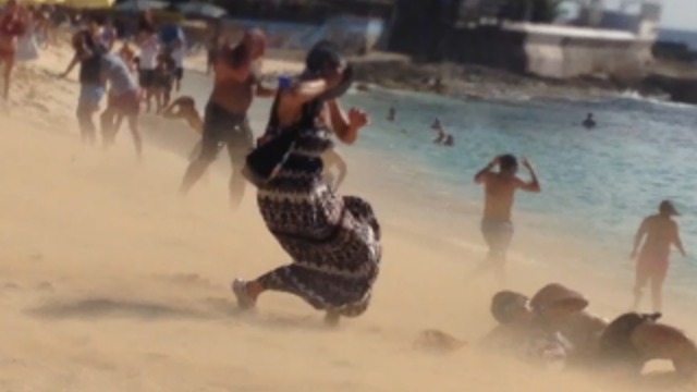 Plane Taking Off Blows People Off The Beach