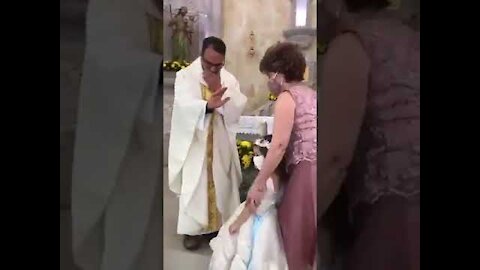 Funny kid thinks the priest wants a high five