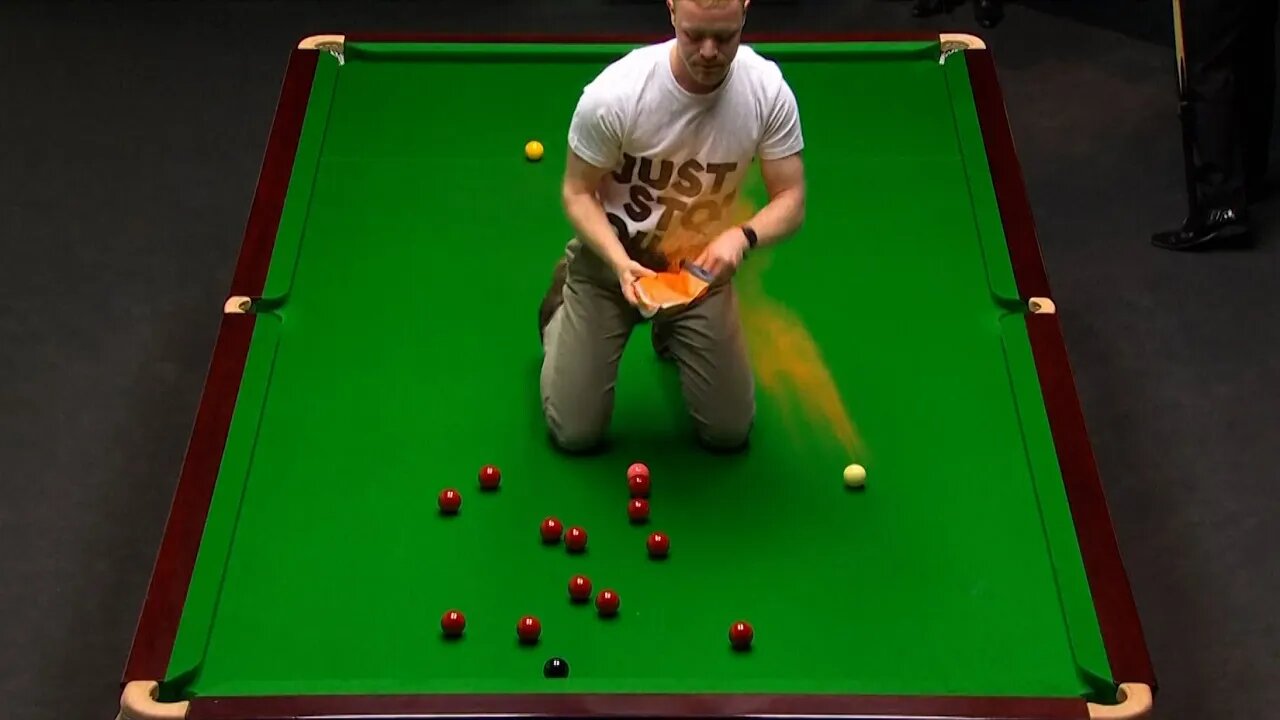 Protester jumps on table at World Snooker Championship, throws orange powder