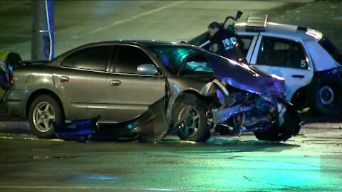 Vehicle blows through red light, crashes with police squad