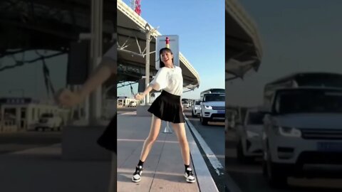 Chinese Girl Dances Outside a Train Station