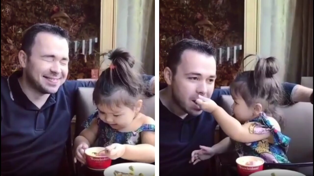 somewhere At a restaurant, a little girl feeds her father ice cream