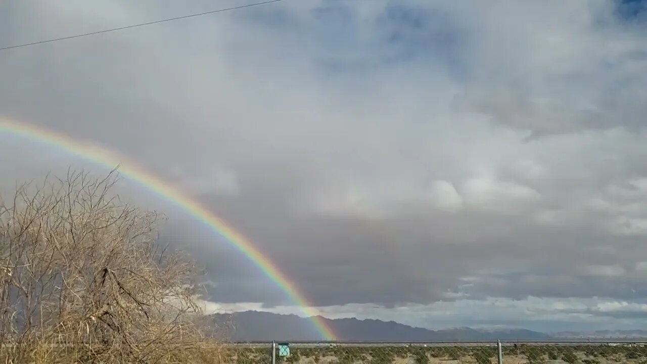 Rainbow Forms Over The Valley