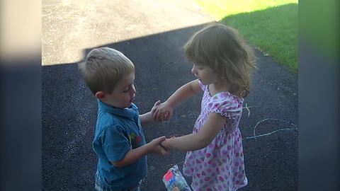 A Tot Girl And A Tot Boy Pretend To Marry Each Other