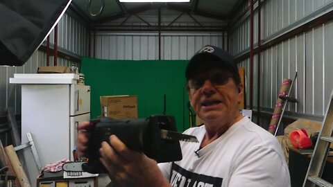 Frank McKay In the shed with the chainsaw.