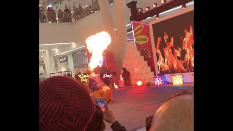 That man playing with fire by his mouth