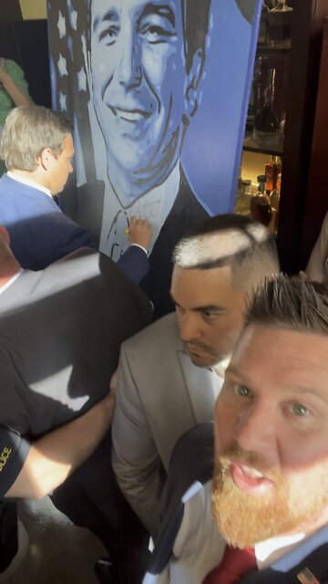 Ron DeSantis signs my painting