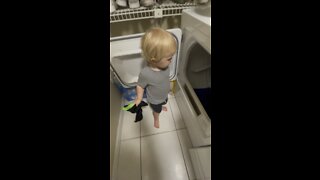 Toddler Helps Daddy Put Clothes in the Dryer