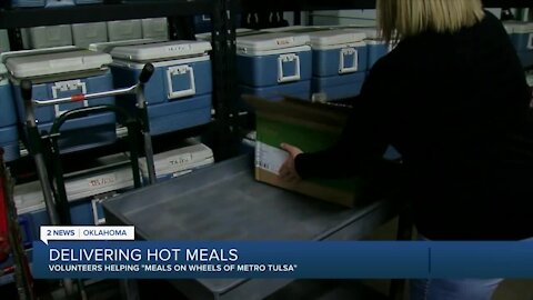 Volunteers helping 'Meals on Wheels' by delivering hot meals