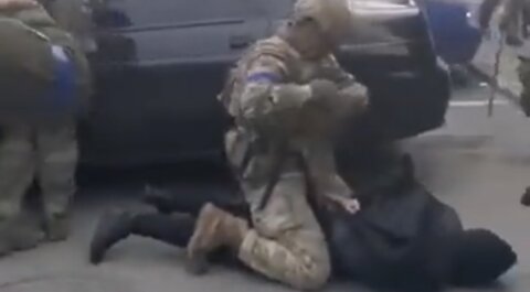 Reports suggest this is Ukrainian troops against civilians accused of "collaborating with Russia"