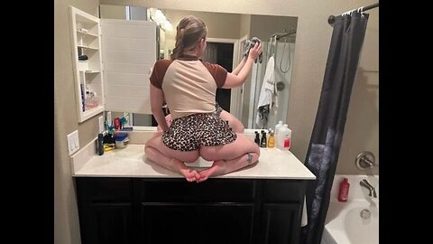 Cleaning mirror in miniskirt