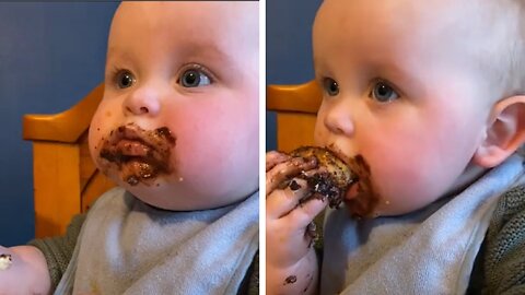 baby eating chocolate cake