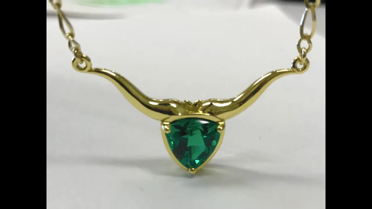 18k Steer necklace with 9mm trillion Chatham lab-grown emerald center