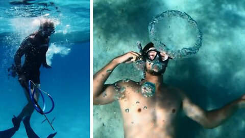 Scuba divers making water rings from mouth