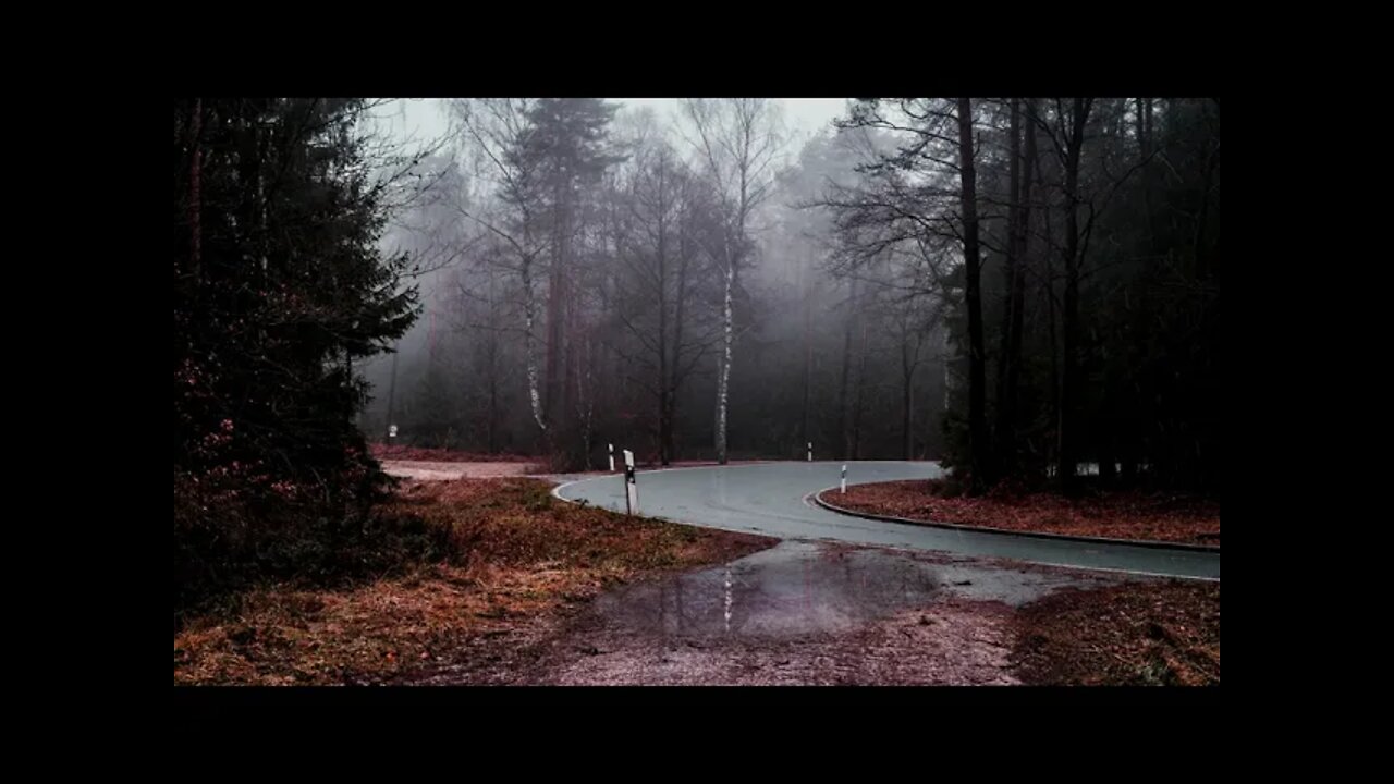 Rainfall on a puddle by a curve in the road