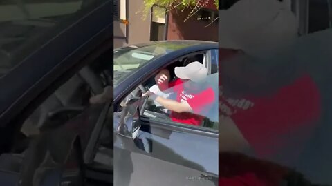 Woman losing it on the street tries to steal a car.