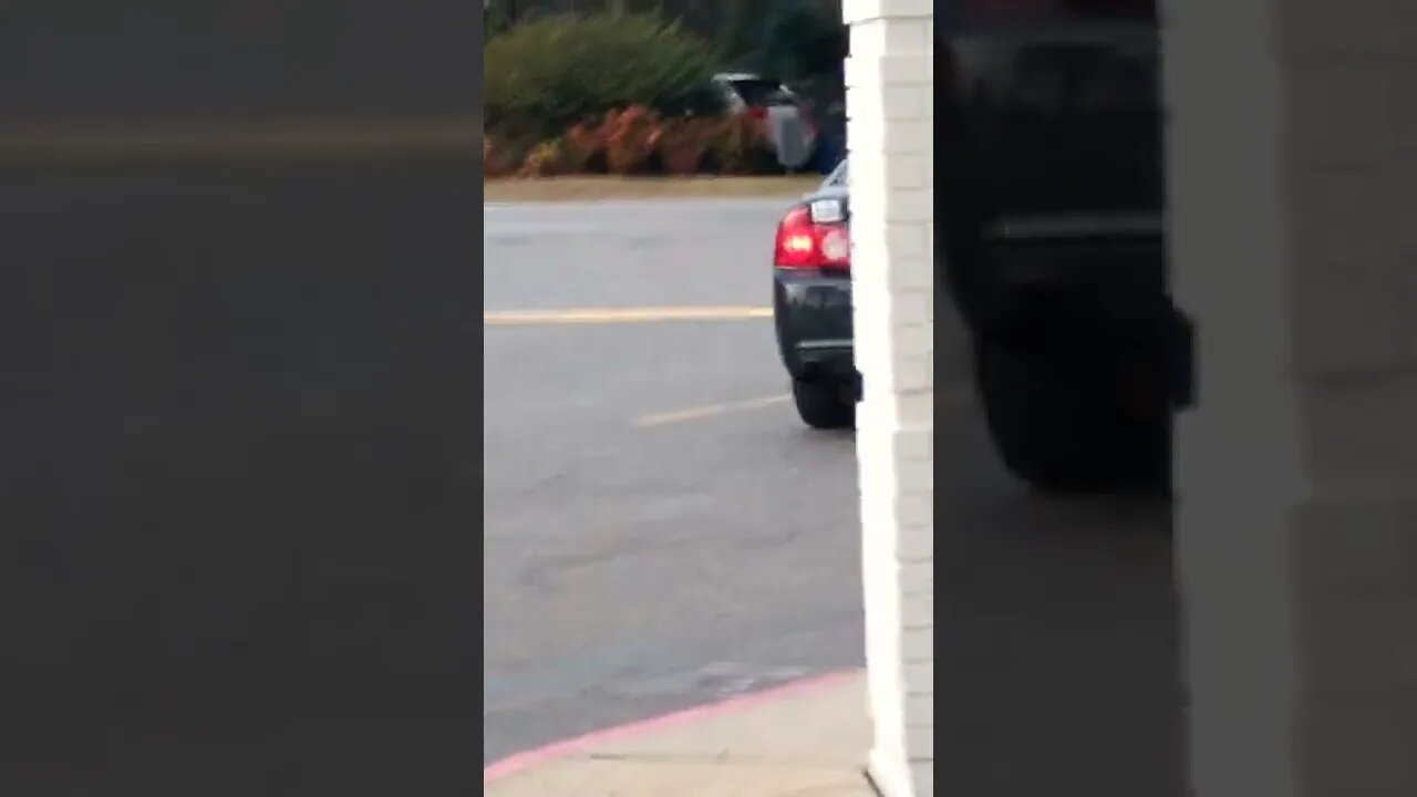 Gang Stalker with his arm hanging out the window