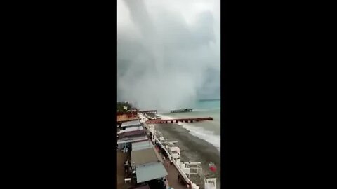 A powerful tornado came out of the sea ashore and destroyed a summer cafe and aerarium