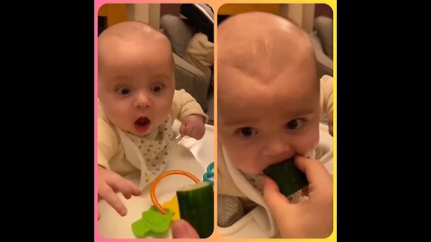 This baby boy is facing cucumber for the first time