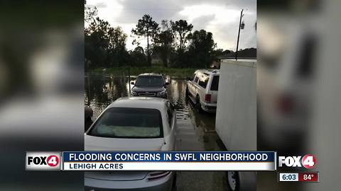 Couple trudges through flooding to go to work