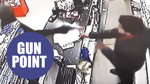 Dramatic CCTV shows have-a-go-hero shopkeeper disarming gunman during terrifying robbery