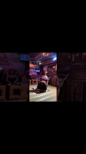 WOMAN RIDES BULL