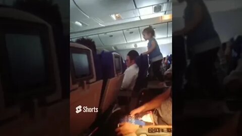 Toddler Was Jumping On Tray Table On The Back On Man's Seat While He Was Trying Sleep!