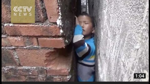 Naughty boy get stuck in narrow wall