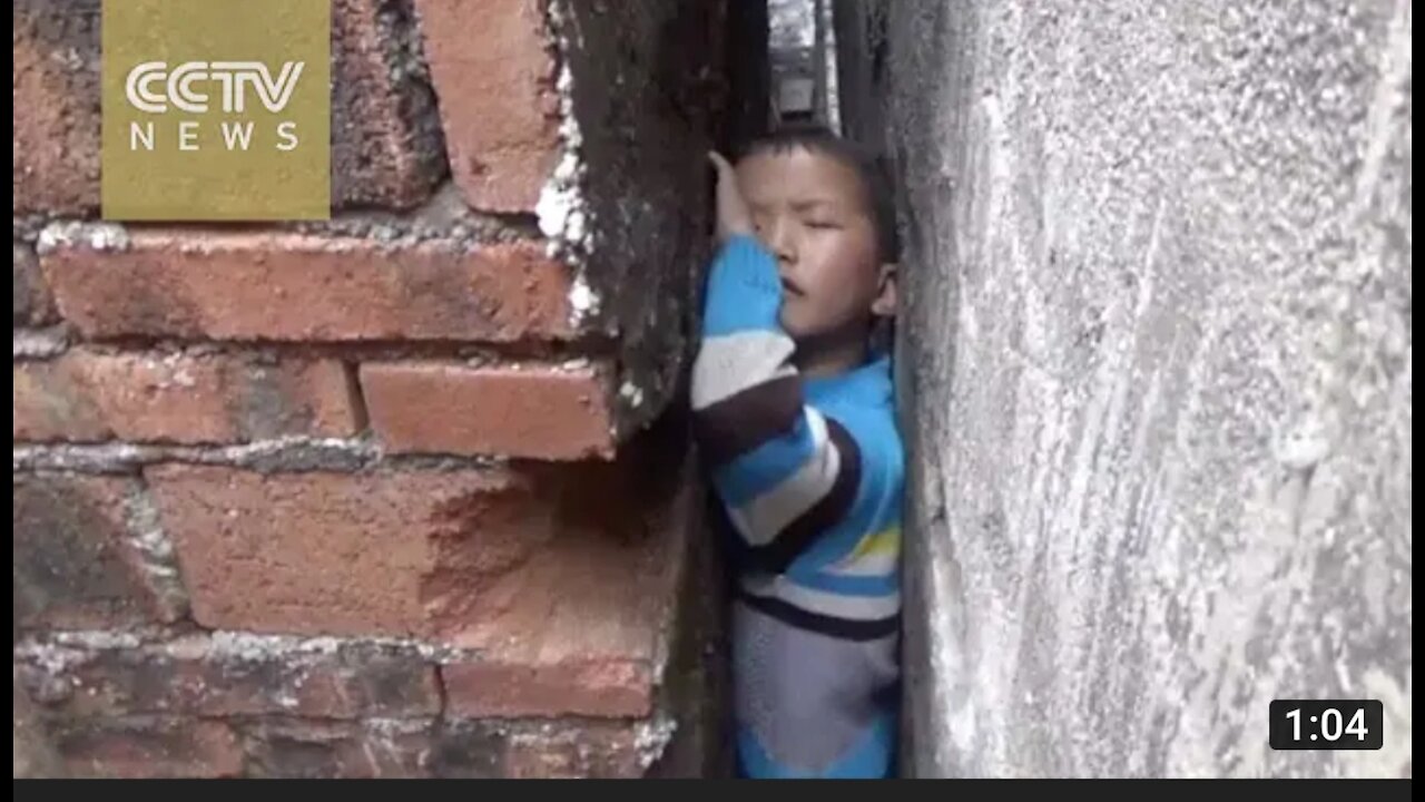 Naughty boy get stuck in narrow wall