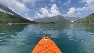 Standup Paddle boarding on a blue crystal clear lake