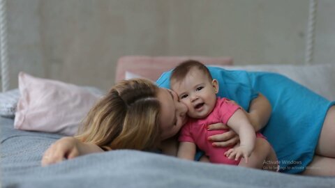 young-mother-kissing-her-baby-girl