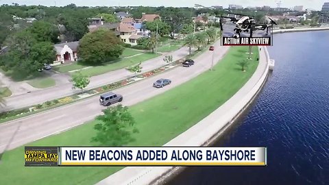 Flashing beacons light up along pedestrian crosswalks on Bayshore Boulevard