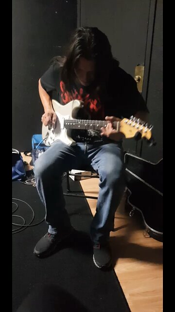 Spotted Elk playing guitar