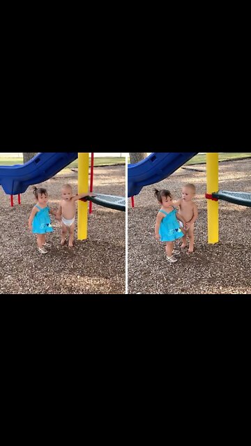Sweet Baby Boy Holds Hands With Little Girl at the Park
