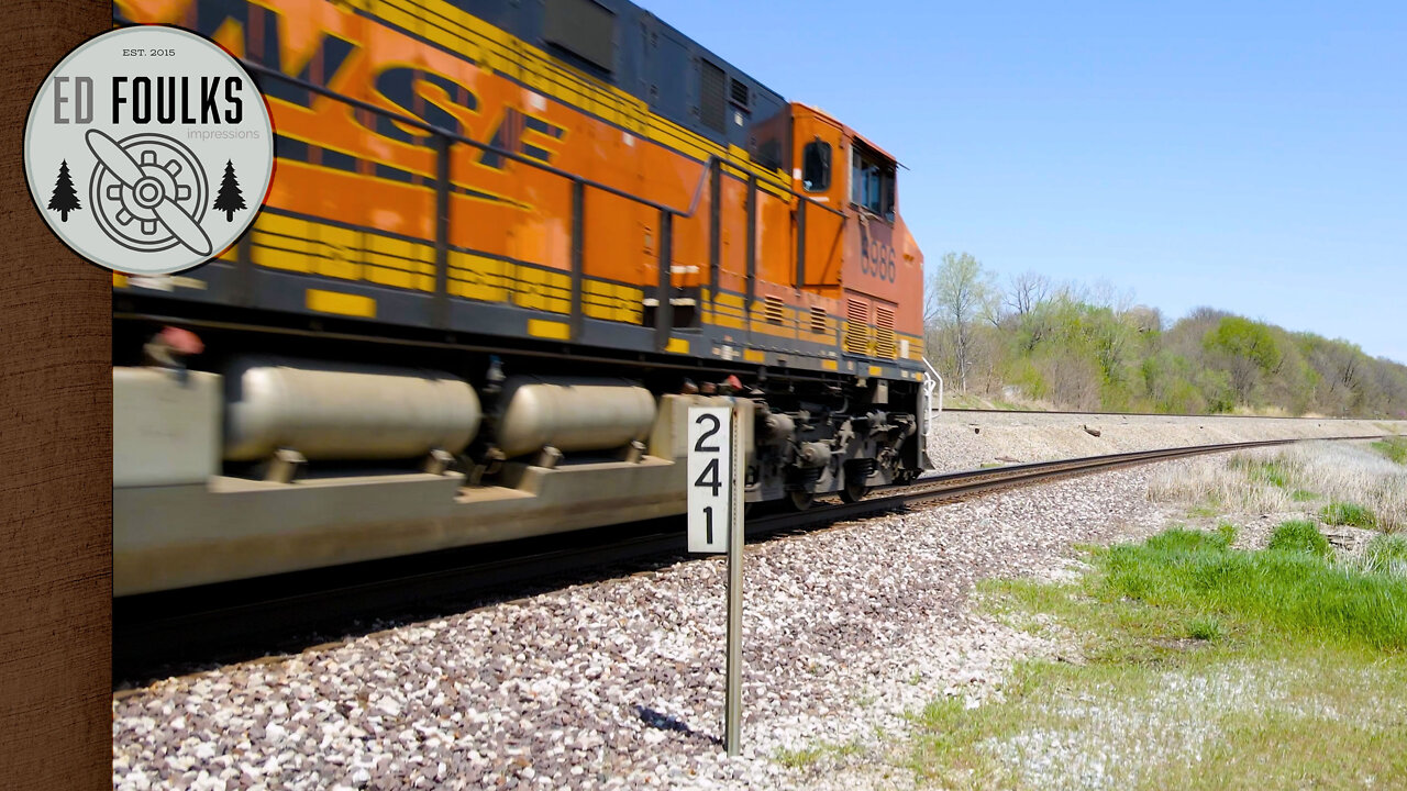 BNSF, KCS, BNSF H2, and NS power pulls an intermodal through Camden, MO on the BNSF Marceline Sub