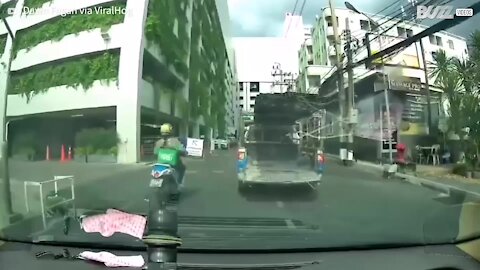 Truck sheds load at parking lot entrance