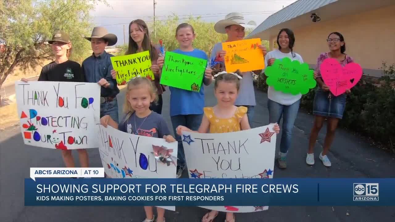 People showing support for Telegraph Fire crews using posters